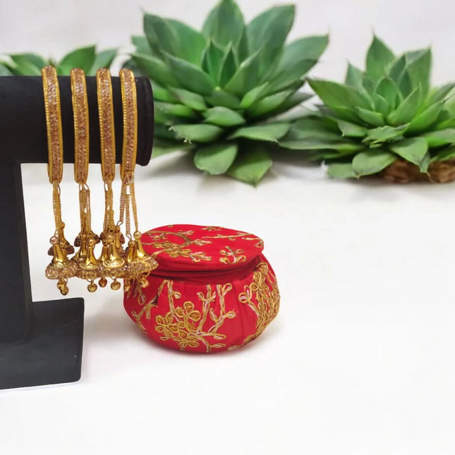 Golden Latkan Bangles with Embroidered Red Potli
