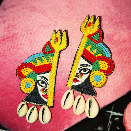 Handmade beaded Durga Ma earrings with golden Trishul design and cowrie shell dangles, festive Navratri jewelry
